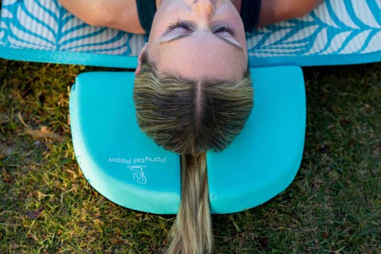 Young woman using a Ponytail Pillow during a Yoga session