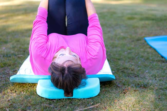 Woman using a ponytail pillow during a workout session