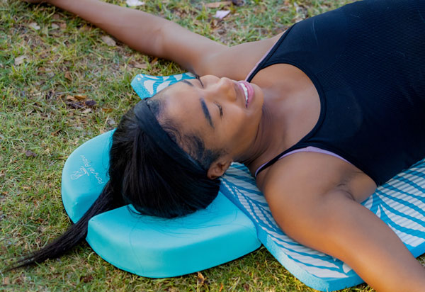 Woman on deeper relaxation using the PonyTail Pillow for ponytail comfort